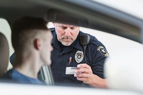 Youth Criminal Law - Criminal Lawyer Winnipeg - Winnipeg Lawyers - Pollock & Company police officer checking id car window